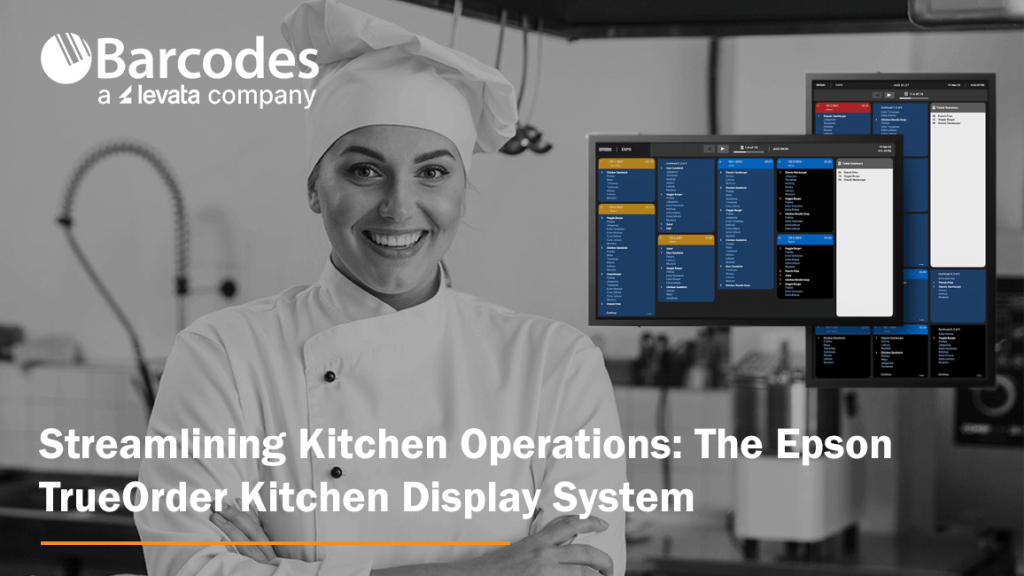 Restaurant kitchen worker with kitchen operations software monitors